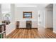 Hallway and bar area with wood flooring, modern refrigerator and bar area at 4797 Stonebriar Dr, Oldsmar, FL 34677