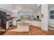 Bright kitchen with granite counters, an island, stainless appliances, a breakfast bar, and wood flooring at 4797 Stonebriar Dr, Oldsmar, FL 34677