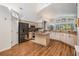 Well-designed kitchen with wood floors, granite counters, island and stainless appliances at 4797 Stonebriar Dr, Oldsmar, FL 34677