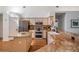 Kitchen with granite counters, stainless appliances, wood flooring, and an island perfect for entertaining at 4797 Stonebriar Dr, Oldsmar, FL 34677