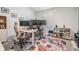 Spacious home office with multiple monitors, a large window, and a patterned rug at 4797 Stonebriar Dr, Oldsmar, FL 34677