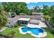 Aerial view of the home's backyard featuring a pool, patio, and well-manicured lawn at 5008 Stolls Ave, Tampa, FL 33615