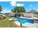 Backyard featuring a blue swimming pool, lanai, and lush landscaping at 5008 Stolls Ave, Tampa, FL 33615