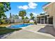 A beautiful backyard featuring a sparkling blue swimming pool and lush landscaping at 5008 Stolls Ave, Tampa, FL 33615
