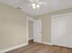 Bedroom features wood-look floors, fresh paint, and a closet with bi-fold doors at 5008 Stolls Ave, Tampa, FL 33615