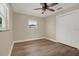Bedroom with wood floors, window and closet at 5008 Stolls Ave, Tampa, FL 33615