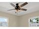 Bedroom featuring a modern ceiling fan with light fixture and large windows at 5008 Stolls Ave, Tampa, FL 33615