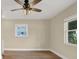 A bright bedroom featuring wood-look floors, a ceiling fan with light, and bright windows at 5008 Stolls Ave, Tampa, FL 33615