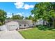 A well-maintained home with a large front yard and a brick facade showcasing curb appeal at 5008 Stolls Ave, Tampa, FL 33615