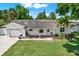 Inviting single story home featuring a well-maintained lawn and beautiful landscaping at 5008 Stolls Ave, Tampa, FL 33615