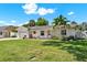 Charming single-story home with a well-manicured lawn and beautiful landscaping at 5008 Stolls Ave, Tampa, FL 33615