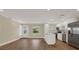 Open floor plan with bright kitchen, white cabinetry, stainless steel appliances, and ample counter space at 5008 Stolls Ave, Tampa, FL 33615