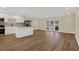 Open kitchen with stainless steel appliances, a center island, and sliding glass doors to the outdoor area at 5008 Stolls Ave, Tampa, FL 33615