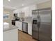 Close-up of modern kitchen with stainless steel appliances, white cabinets, and ample counter space at 5008 Stolls Ave, Tampa, FL 33615