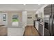Well-lit kitchen featuring an island with quartz countertops, stainless steel appliances, and a view to the yard at 5008 Stolls Ave, Tampa, FL 33615