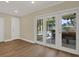 Bright living area with sliding doors that open to a patio, complete with outdoor furniture and pool views at 5008 Stolls Ave, Tampa, FL 33615