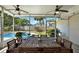 Screened-in patio with dining table and chairs overlooks the pool and backyard at 5008 Stolls Ave, Tampa, FL 33615