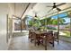 Screened-in patio with a wooden table and chairs overlooking the pool at 5008 Stolls Ave, Tampa, FL 33615