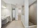 Bathroom with and sinks, stone floors, and stand up shower at 5116 Wildwind Dr, Apollo Beach, FL 33572