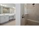 Bathroom with and sinks, stand up shower, and a window to look outside at 5116 Wildwind Dr, Apollo Beach, FL 33572