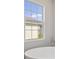 Bright bathroom featuring a soaking tub under a window with neighborhood views at 5116 Wildwind Dr, Apollo Beach, FL 33572