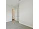 Neutral bedroom with carpeting, doorways to other rooms, and a clean design at 5116 Wildwind Dr, Apollo Beach, FL 33572