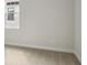 Calm bedroom corner with window, neutral walls, and plush carpeting at 5116 Wildwind Dr, Apollo Beach, FL 33572
