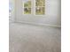 Bright and airy bedroom with large windows, and soft neutral carpeting at 5116 Wildwind Dr, Apollo Beach, FL 33572