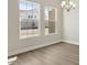 Elegant dining room featuring light wood flooring, chandelier, and bright windows at 5116 Wildwind Dr, Apollo Beach, FL 33572