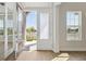 Bright foyer with modern floors and glass door offering a glimpse of the outdoors, creating an inviting entrance at 5116 Wildwind Dr, Apollo Beach, FL 33572