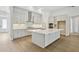 Modern kitchen with white cabinets, stainless steel appliances, and a spacious island perfect for cooking and entertaining at 5116 Wildwind Dr, Apollo Beach, FL 33572