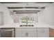 Kitchen island features a stainless sink and a large marble countertop at 5116 Wildwind Dr, Apollo Beach, FL 33572