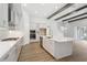 Bright, modern kitchen with large island, stainless appliances, and beautiful wood floors at 5116 Wildwind Dr, Apollo Beach, FL 33572