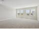 Bright living room with neutral carpet, recessed lighting, and multiple windows offering views at 5116 Wildwind Dr, Apollo Beach, FL 33572