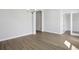 Bright room with light wood floors featuring modern lighting and glass door access at 5116 Wildwind Dr, Apollo Beach, FL 33572