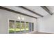 Bright living room featuring wooden beams, lots of space and sliding glass doors offering seamless indoor-outdoor living at 5116 Wildwind Dr, Apollo Beach, FL 33572