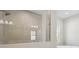Stand up shower with a glass wall and tiled wall at 5116 Wildwind Dr, Apollo Beach, FL 33572