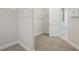 Spacious walk-in closet with wire shelving and neutral carpeting for ample storage at 5116 Wildwind Dr, Apollo Beach, FL 33572
