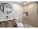 Bright bathroom featuring a vessel sink, round mirror, and walk-in glass shower at 535 31St N Ave, St Petersburg, FL 33703