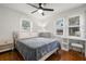 Bright bedroom features hardwood floors, two windows, a ceiling fan, and makeup vanity at 535 31St N Ave, St Petersburg, FL 33703