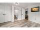 Bright bedroom boasts white-painted walls, modern plank flooring, and access to an ensuite bathroom and kitchen at 535 31St N Ave, St Petersburg, FL 33703