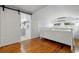 Bright bedroom with hardwood floors, sliding barn door bathroom access, and AC at 535 31St N Ave, St Petersburg, FL 33703