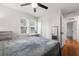 Bright bedroom features hardwood floors, two windows, a ceiling fan, closet, and bathroom access at 535 31St N Ave, St Petersburg, FL 33703