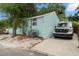 Charming exterior view of light blue home with tidy landscaping and convenient driveway parking at 535 31St N Ave, St Petersburg, FL 33703