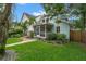 A beautiful light blue home featuring a spacious, screened-in front porch and well-manicured green lawn and garden at 535 31St N Ave, St Petersburg, FL 33703