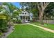 Lovely single-Gathering home with a welcoming screened-in porch, lush green lawn and stone walkway leading to the entrance at 535 31St N Ave, St Petersburg, FL 33703