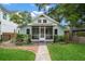 Charming light blue single-Gathering home featuring a screened-in front porch and a well-maintained, landscaped front yard at 535 31St N Ave, St Petersburg, FL 33703