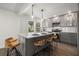 Modern kitchen with gray cabinetry, stainless steel appliances, a marble island, and pendant lighting for a sleek look at 535 31St N Ave, St Petersburg, FL 33703