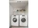 Convenient laundry room with a washer, dryer, and storage shelving at 535 31St N Ave, St Petersburg, FL 33703