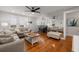 Sunlit open living space with hardwood floors, comfortable seating, and a large mirror that expands the space at 535 31St N Ave, St Petersburg, FL 33703